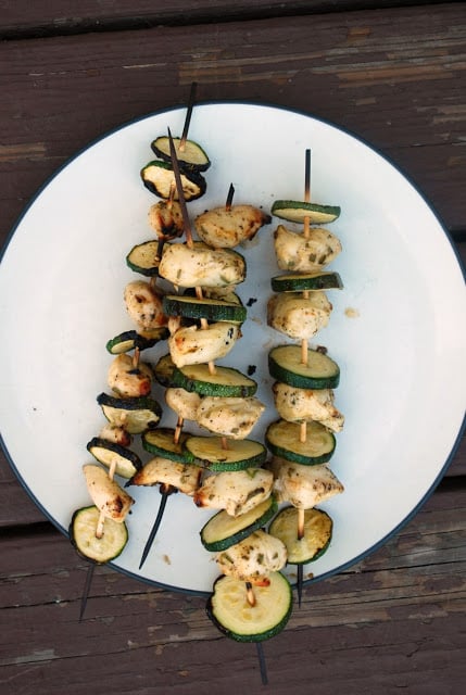 Skewers of Rosemary Chicken and Zucchini - Perfect weeknight summer grilling recipe! a plate with skewers of chicken and zucchini on it