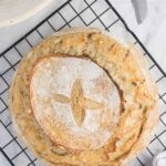 sourdough bread loaf on wire cooling rack