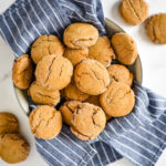 sourdough molasses cookies in dish with blue striped cloth