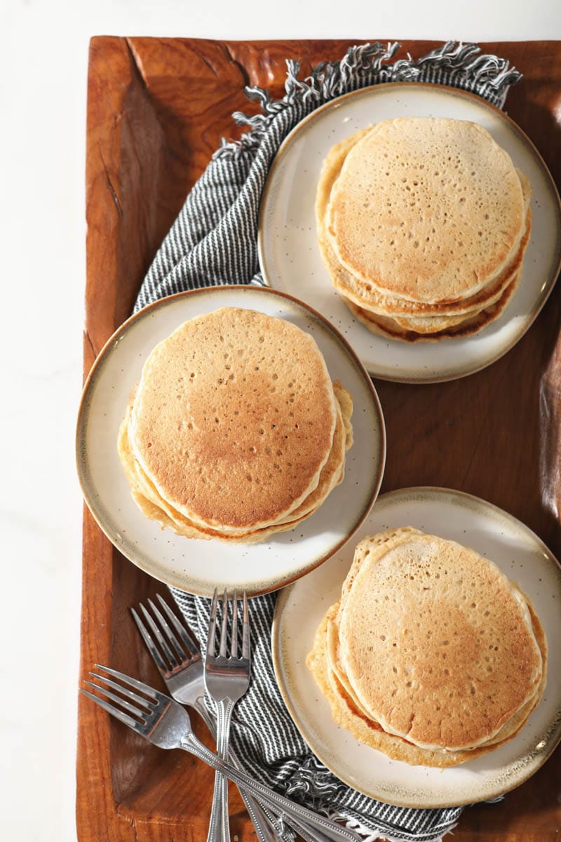 stacks of sourdough pancakes on three plates